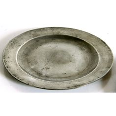 a silver plate sitting on top of a white table