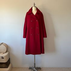 "A gorgeous rich red coat in perfect condition! Its a larger sized coat. A great piece to add to your wardrobe for this fall winter season. There are pockets, it's double breasted with 8 buttons running down the front and there is a satin lining to it with a ribbon to help it keep in place at the waist. The buttons can also close at the neck collar area to keep your chest a bit warmer on colder days and evenings. This coat has a mod style to it so it is not meant to be very fitted to the body. S Classic Red Wool Coat, Red Wool Coat For Winter Formal, Red Wool Coat For Winter Formal Events, Elegant Red Pea Coat With Buttons, Elegant Red Pea Coat For Formal Occasions, Red Winter Formal Pea Coat, Red Formal Winter Pea Coat, Elegant Red Long Pea Coat, Elegant Long Red Pea Coat