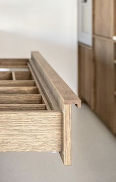 a close up of a wooden bench with drawers