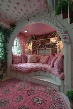 a living room with pink furniture and flowers on the walls, along with rugs