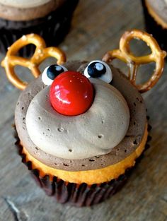 cupcakes with frosting and pretzels decorated as reindeer's noses