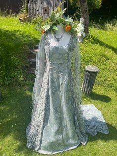 a dress is on display in the grass