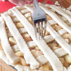 a fork is stuck into the top of a pie with white icing on it