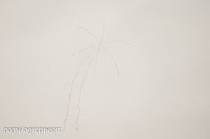 a drawing of a palm tree on a white wall