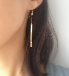 Simple and sleek, these lightweight gold diamond bar earrings are just gorgeous. So easy to wear with almost any outfit. Hand-formed 14k gold fill french hooks with 14k gold fill chain and bar. I flushed set a tiny diamond cz on the ends of each bar. 2 1/8 inches long from chain to bar. I provide two clear rubber backings with these earrings. If you would like a complete matching set, here are links to matching necklaces and a bracelet: Necklaces - 1) https://www.etsy.com/listing/192922687/horiz Minimalist Diamond Earrings For Anniversary, Sleek Single Earring Jewelry For Gift, Minimalist Diamond Drop Earrings, Gold Minimalist Single Diamond Earring, Minimalist Hypoallergenic Diamond Drop Earrings, Hypoallergenic Minimalist Diamond Earrings For Formal Occasions, Sleek Earrings For Gift, Gold Minimalist Pierced Diamond Earrings, Minimalist Dangle Diamond Earrings