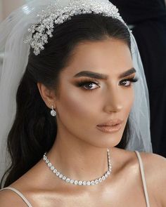 a woman wearing a bridal veil and tiara