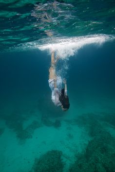 a man swimming under water with the words sometimes it takes a good fall to really know where you stand