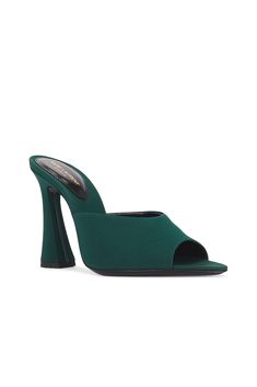 Find SAINT LAURENT Suite Mule Sandal In Dark Green on Editorialist. Saint Laurent Suite Mule Sandal in Dark Green Satin fabric upper and leather sole. Made in Italy. Pointed toe. Flared heel. Padded insole. Approx 100mm/ 4 inch heel. SLAU-WZ1160. 766829-AAAKY-3017. About the designer: SAINT LAURENT has been influencing and revolutionizing the fashion industry since the debut of its iconic ‘Rive Gauche’ collection in 1966 - the couture house was the first to create a ready-to-wear capsule. The sl Evening Sandals With Single Toe Strap In Green, Evening Green Sandals With Single Toe Strap, Green Formal Sandals With Single Toe Strap, Green Heel Strap Sandals For Evening, Green Evening Sandals With Heel Strap, Green Evening Sandals With Wrapped Heel, Evening Green Sandals With Heel Strap, Green Open Toe Formal Mules, Green Sandals With Sculpted Heel