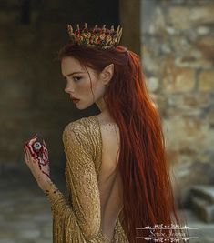 a woman with long red hair wearing a crown