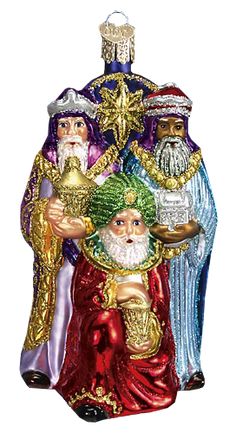 the three wise men ornament is hanging on a blue background with gold trimmings