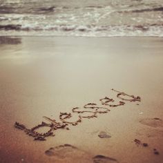 the word do something written in the sand at the beach