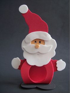 a red and white paper santa clause on a black background