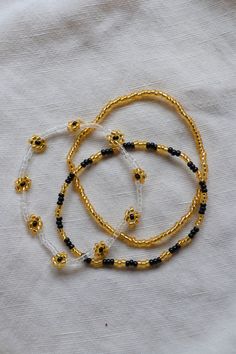 The cutest black and gold stacking set for some Saints pride. This listing is for 3 bracelets! They are made on a stretchy string for easy on and off. Adjustable Gold Stretch Bracelet For Festivals, Black Stretch Bracelet With Tiny Beads As Gift, Gold Beaded Stretch Bracelet For Festivals, Gold Beaded Bracelets With Letter Beads For Festival, Gold Beaded Bracelets With Black Beads For Festivals, Festival Gold Beaded Bracelets With Black Beads, Gold Letter Beads Bracelets For Festival, Gold Festival Bracelets With Letter Beads, Gold Bracelets With Letter Beads For Festivals