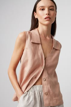 "LUCY is a collared linen vest. DETAILS - Fits true to size - Collared - Sleeveless design - Small coconut buttons closure, also available with large coconut buttons - 100% lightweight European linen fabric - Cut and sewn to order just for you in our studio COLOR - Camel, you can also choose other colors above - Fabric samples are available here https://www.etsy.com/listing/586569696/linen-fabric-samples SIZING & FIT - Relaxed, loose fit - Model is 5'9.5\" / 177cm tall and usually wears size S CARE FOR LINEN - Machine wash up to 30ºC/86ºF gentle cycle - Lay flat to dry or tumble dry low - Warm iron if needed - Do not bleach SIZE GUIDE Size conversion guide Size XS (US 0-2, IT 36-38, UK 4-6, Japan 3-5, France 32-34) Size S (US 4-6, IT 40-42, UK 8-10, Japan 7-9, France 36-38) Size M (US 8-10 Womens Linen Shirt, Sleeveless Linen Shirt, Shirt Linen Woman, Sleeveless Button Up Shirt Outfit, Sleeveless Outfits For Women, Sleeveless Button Up, Sleeveless Button Down Shirt Outfit, Sleeveless Shirt Outfit, Sleeveless Collared Shirt