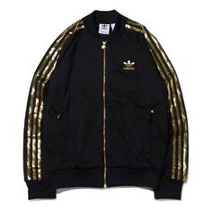 The adidas originals SST 24 Track Jacket Gold Stripe Retro Sports Black is the perfect combination of style and comfort. This sleek black jacket features a classic silhouette with a modern twist, including a gold stripe detail and a retro sports look. It is designed to keep you warm and comfortable during any activity, from running to hiking. The inspiration behind this jacket comes from the adidas Originals SST series, which is renowned for its timeless style and quality craftsmanship. This jac Fall Athleisure Track Jacket With Three Stripes Branding, Fall Sportswear Track Jacket With Three Stripes, Fall Track Jacket With Three Stripes Branding, Fall Track Jacket With Three Stripes, Adidas Track Jacket With Logo For Fall, Adidas Athleisure Outerwear For Fall, Hooded Track Jacket With Three Stripes For Fall, Fall Adidas Logo Outerwear For Streetwear, Adidas Logo Outerwear For Fall Streetwear