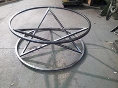 a metal object sitting on top of a cement floor next to other items in a warehouse