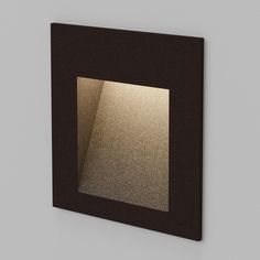 a square light in the middle of a wall with a black frame on it's side