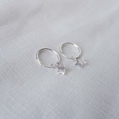 Real 925 Sterling Silver Dainty Star Hoop Earrings These lovely hoop earrings can be used in Earlobes and second ear holes. Outer Diameter Measures 12mm Star Charm Measures 6mm Sold by Pair Jewelry will come in a gift box * Please read shop policy before placing an order * *JEWELRY CARE* Sterling Silver will tarnish over time, but to help keep your jewelry looking beautiful - Clean with a soft dry cloth after wear and store inside an airtight bag or container. Remember to remove your jewelry whe Nickel-free Star-shaped Huggie Earrings, Silver Dangle Hoop Earrings With Star Charm, Minimalist Silver Star Hoop Earrings, Sterling Silver Star Charm Huggie Earrings, Minimalist Star-shaped Sterling Silver Huggie Earrings, Silver Star-shaped Hoop Earrings For Everyday, Sterling Silver Star Huggie Earrings Minimalist Style, Minimalist Sterling Silver Star Huggie Earrings, Sterling Silver Star Shaped Minimalist Huggie Earrings