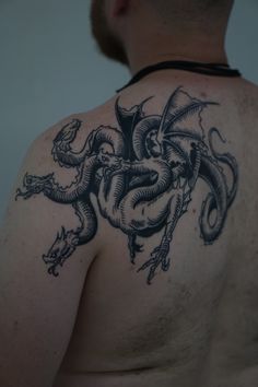 a man with a dragon tattoo on his back