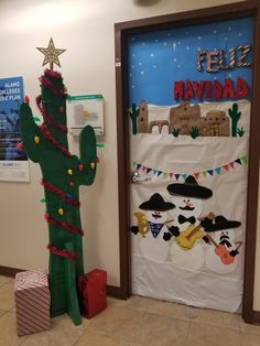 a door decorated to look like a cactus with decorations on it and the words feliz navidad