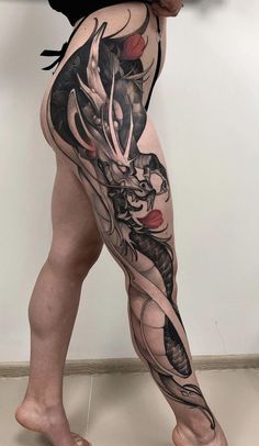 a woman's leg with tattoos on it