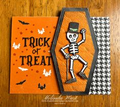 a trick or treat card with a skeleton on it and bats in the back ground