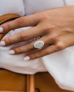 a woman's hand with a diamond ring on it