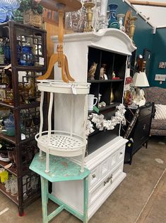 an antique furniture store with lots of items in the background and on display shelves next to each other