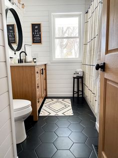 a bathroom with black and white tile flooring