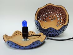 a blue and brown object sitting on top of a white table next to a black cord