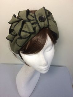 Olive green turban headband. A real statement piece with a standard width inner Alice band attached within the lining to provide an easy to wear design. Completed with quills of fabric, buttons and lined with a fine fleece. The perfect accessory for style and added warmth. This unique creation is a stunning example of a vintage inspired accessory with an eye catching easy to wear and lightweight design. Bohemian Green Headwrap As Headband, Adjustable Green Turban With Matching Headband, Green Hair Accessories With Matching Headband, Bohemian Green Headwrap Style Headband, Fitted Green Headwrap Headband, Adjustable Green Headwrap With Matching Headband, Green One Size Turban Headband, Adjustable Green Hair Accessories With Headband, Green Bohemian Headband