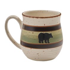 a brown and green striped mug with a black bear on it