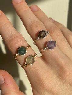 These stunning rings make the perfect promise rings, friendship rings, Mother's day rings or a special gift to self✨ Product details: each ring is made with your choice of silver or gold tarnish resistant wire and four different faceted crystals to choose from - black lace agate, indian agate, fluorite, and amethyst!   All rings are wire wrapped by hand with lots of love and come in US sizes 2-16!  Gift Wrapping: All rings are wrapped up in beautifully designed organza bags - you may choose to include a gift message for you loved one and i will place it in the bag :) ✨Healing Properties✨ Amethyst: a natural tranquiliser, it relieves stress and strain, soothes irritability, balances mood swings, dispels anger, rage, fear and anxiety. Indian Agate: said to promote strength, courage, and prot Adjustable Emerald Ring As Gift, Hand Wrapped Ring For Promise Ring, Hand Wrapped Ring For Promise, Hand-wrapped Promise Ring, Unique Stackable Crystal Ring As Gift, Unique Stackable Crystal Ring For Gift, Handmade Adjustable Ring With Round Stone, Adjustable Crystal Toe Ring For Promise, Hand Wrapped Crystal Promise Ring