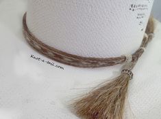 Horsehair hat band:: IMPRESSIVE ! All natural horsehair hat band: stunning design, genuine Horsehair in the BOLDEST Western design. Color : Cinnamon brown and natural white ** all natural horsehair Unique, distinctive and exceptional quality Cowboy horsehair hat band! * Everything you want in a Horsehair hat band. * This is a 5 strand horsehair hat and that is about 5/8 inches wide. * Easy adjusts You will find it easy to adjust to fit most any size hat with sliding knots. Brings out your spirit Adjustable Flat Brim Hat With Fringe, Rustic Adjustable Handmade Hat Bands, Adjustable Brown Mini Hat For Rodeo, Bohemian Adjustable Beige Mini Hat, Adjustable Bohemian Beige Mini Hat, Bohemian Beige Adjustable Mini Hat, Adjustable Brown Mini Hat As Gift, Adjustable Brown Mini Hats As Gifts, Adjustable Brown Mini Hats As Gift