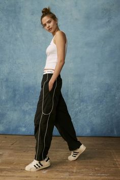 Effortless track pants from BDG. Our BDG Jess nylon track pants have an easy fit with a low rise and a relaxed straight leg. Essential track pants styling with contrasting piping at the sides. Find these staple track pants only at Urban Outfitters. Features BDG Jess nylon track pants with piped detailing Relaxed style with classic track pant styling Side pockets Pull-on style UO exclusive Content + Care 100% Nylon Machine wash Imported Size + Fit Model in Black is 5’10" and wearing size Small Me Sporty Straight Cargo Pants For Spring, Spring Streetwear Joggers With Elastic Side Panels, Straight Cargo Pants For Streetwear Athleisure, Athleisure Straight Cargo Pants For Streetwear, Urban Style Bottoms For Spring Jogging, Trendy Streetwear Activewear Long Pants, Sporty Black Parachute Pants For Summer, Sporty Straight Leg Summer Cargo Pants, Sporty Straight Cargo Pants For Summer