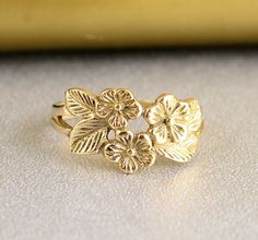 a gold ring with flowers on it