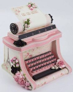 an old fashioned pink typewriter with roses on it