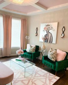 a living room with two green couches and a coffee table in front of the window