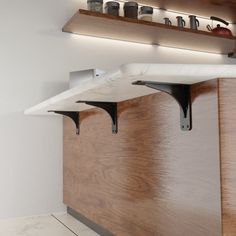 a kitchen counter with wooden shelves above it