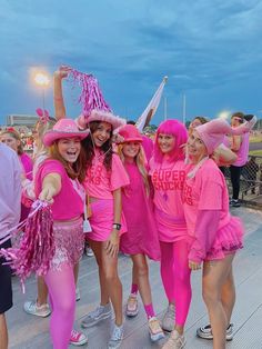 some girls in pink are posing for the camera