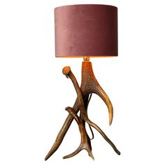 a table lamp with antlers on it and a brown lampshade over it