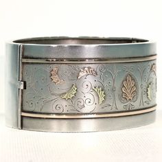 Whenever I talk about antique jewelry, I like to refer to it as 'wearable art', no where is this more clearly seen than with English Victorian silver jewelry. Each bangle, collar, earring, locket, was lovingly and elaborately made, with gold overlay, with fantastic engraving, with embossed designs, one piece more stunningly detailed than the next. This fabulous bangle was hand crafted in England around 1880. It has a lovely soft bloomed finish and is decorated with richly detailed engraving and Ceremonial Vintage Jewelry With Historical Design, Vintage Ceremonial Jewelry With Historical Design, Heirloom Jewelry With Intricate Design For Collectors, Victorian Historical Jewelry For Formal Occasions, Victorian Style Jewelry With Historical Design For Formal Occasions, Victorian Hallmarked Formal Jewelry, Silver Heirloom Jewelry With Historical Design, Heirloom Silver Jewelry With Historical Design, Silver Historical Design Jewelry For Wedding