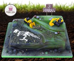 there is a cake that has been made to look like a construction site on the ground