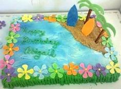 a birthday cake decorated with flowers and surfboards