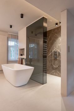 a large white bath tub sitting inside of a bathroom next to a walk in shower