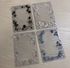 four pieces of clear glass sitting on top of a table