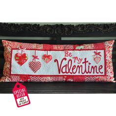 a valentine pillow on a bench with the words be my valentine