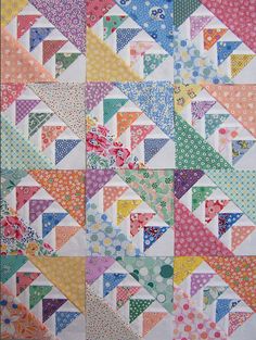 a colorful quilt with many different colored triangles