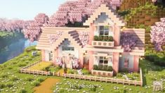 a large pink house sitting on top of a lush green hillside