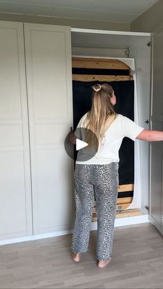 a woman standing in front of an open closet